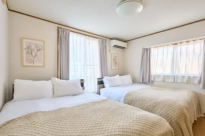 a bedroom with two beds and a window at JR ChuoLine Aasagaya station 5min,Shinjuku 8min Max15pp 2WC in Tokyo