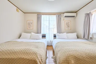 two beds in a room with a window at JR ChuoLine Aasagaya station 5min,Shinjuku 8min Max15pp 2WC in Tokyo