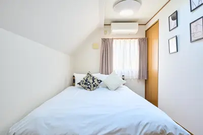 a bedroom with a white bed with pillows on it at JR ChuoLine Aasagaya station 5min,Shinjuku 8min Max15pp 2WC in Tokyo
