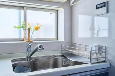a kitchen sink with a dish rack next to a window at JR ChuoLine Aasagaya station 5min,Shinjuku 8min Max15pp 2WC in Tokyo