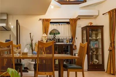 a dining room with a wooden table and chairs at 3 minutes walk to the station, direct to Ikebukuro, two-story house with a garden in Tokyo