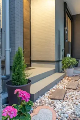 a front porch of a house with pink flowers at 3 minutes walk to the station, direct to Ikebukuro, two-story house with a garden in Tokyo