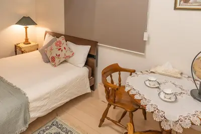 a bedroom with a bed and a table with a chair at 3 minutes walk to the station, direct to Ikebukuro, two-story house with a garden in Tokyo