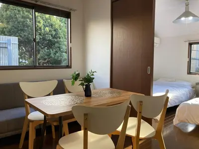 a room with a table and chairs and a bed at AI-Daikannyama 201 in Tokyo