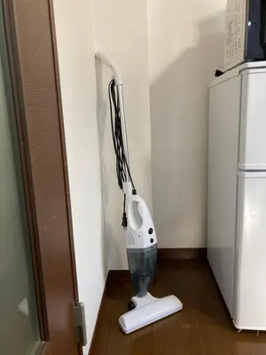 a hair dryer sitting on the floor next to a refrigerator at AI-Daikannyama 201 in Tokyo