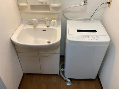 a small bathroom with a sink and a washing machine at AI-Daikannyama 201 in Tokyo
