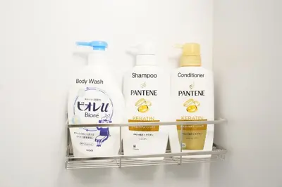 a shelf with a bunch of products on it at Shirokanedai guest suite in Tokyo