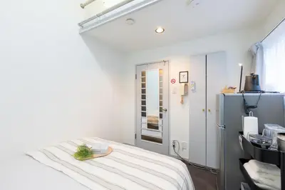 a hospital room with a bed with a tray on it at Shirokanedai guest suite in Tokyo