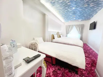 a hotel room with two beds and a desk at Hotaku HOTEL - Vacation STAY 37344v in Tokyo