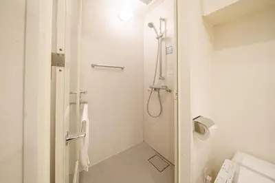 a white bathroom with a shower and a toilet at Pangoo Shinagawa Room 502 - Vacation STAY 99413v in Tokyo