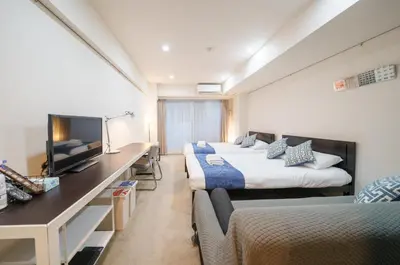 a hotel room with two beds and a flat screen tv at Pangoo Shinagawa Room 502 - Vacation STAY 99413v in Tokyo