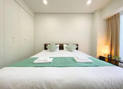 a bedroom with a large white bed with two pillows at Pangoo Shinagawa Room 203 - Vacation STAY 03802v in Tokyo