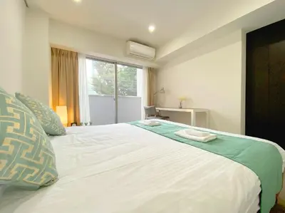 a bedroom with a large white bed with a window at Pangoo Shinagawa Room 203 - Vacation STAY 03802v in Tokyo