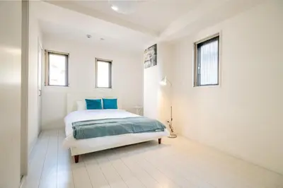 a white bedroom with a bed and two windows at Oceans Residence Urayasu - Vacation STAY 18420 in Tokyo