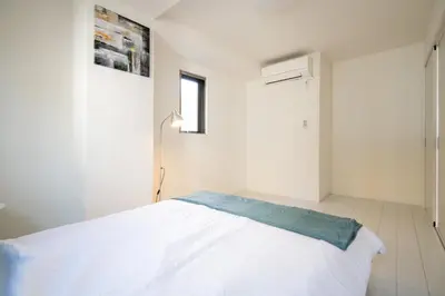 a white bedroom with a bed and a window at Oceans Residence Urayasu - Vacation STAY 18420 in Tokyo