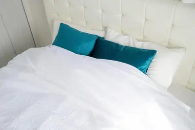 a white bed with blue pillows on it at Oceans Residence Urayasu - Vacation STAY 18420 in Tokyo