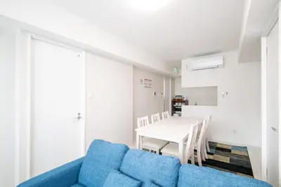 a living room with a blue couch and a table at Oceans Residence Urayasu - Vacation STAY 18420 in Tokyo