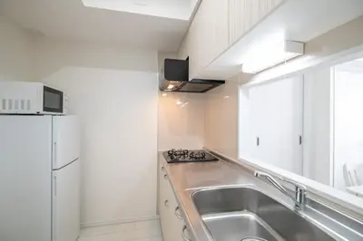 a kitchen with a stainless steel sink and a refrigerator at Oceans Residence Urayasu - Vacation STAY 18420 in Tokyo