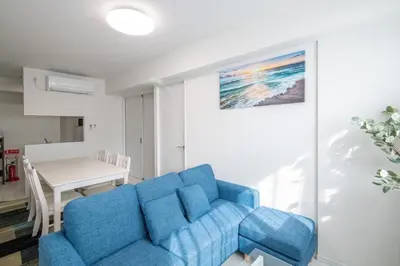 a blue couch in a living room with a table at Oceans Residence Urayasu - Vacation STAY 18420 in Tokyo