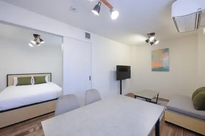 a bedroom with a bed and a table and chairs at \u30d3\u30e5\u30fc\u30ceSumida in Tokyo