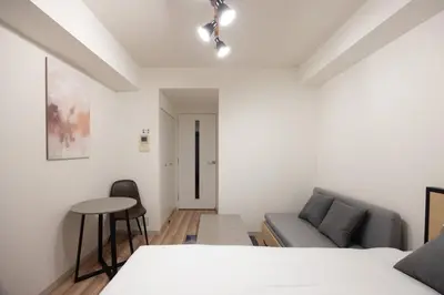 a living room with a couch and a table at \u30ec\u30b8\u30c7\u30a3\u30a2\u4e2d\u843d\u5408a in Tokyo