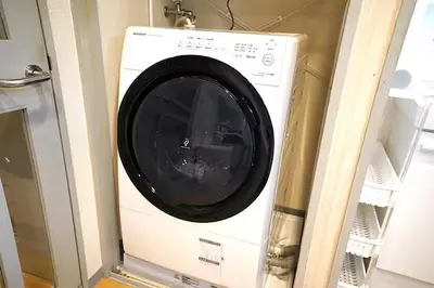 a washing machine sitting inside of a room at Room 202 Nishi-Shinjuku Gochome 9 minutes walk 40 square meters Sleeps up to 6 people in Tokyo