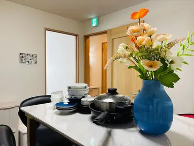 a blue vase with flowers on a kitchen counter at Lapis House - Vacation STAY 03045v in Tokyo