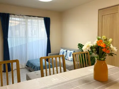 a dining room table with a vase of flowers on it at Lapis House - Vacation STAY 03045v in Tokyo