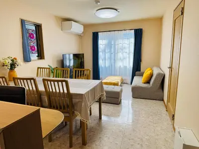 a dining room with a table and chairs and a couch at Lapis House - Vacation STAY 03045v in Tokyo