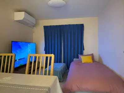 a small room with two beds and a tv at Lapis House - Vacation STAY 03045v in Tokyo