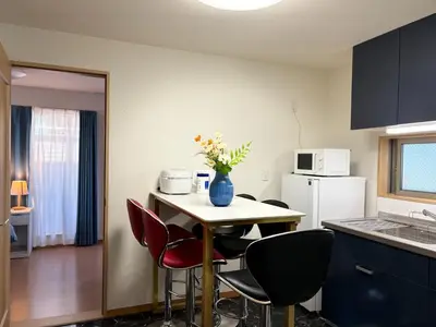 a kitchen with a table with chairs and a vase with flowers at Lapis House - Vacation STAY 03045v in Tokyo