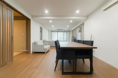 a dining room and living room with a table and chairs at \u7af9\u5185\u30d3\u30eb in Tokyo