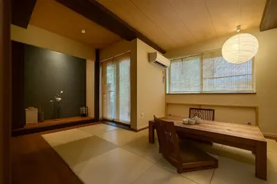 a dining room with a table and a large window at \u7af9\u5185\u30d3\u30eb in Tokyo