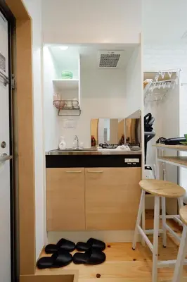 a small kitchen with a sink and a counter at Zenith Shinjuku Hinoki by Tranova in Tokyo