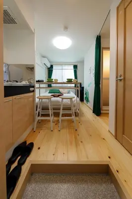 a kitchen with a table and chairs in a room at Zenith Shinjuku Hinoki by Tranova in Tokyo