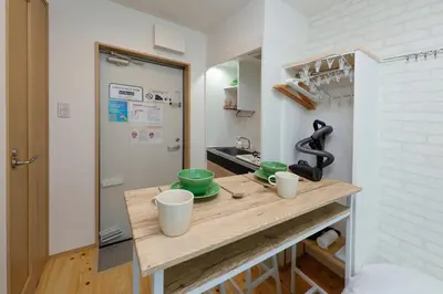 a kitchen with a counter with cups on it at Zenith Shinjuku Hinoki by Tranova in Tokyo