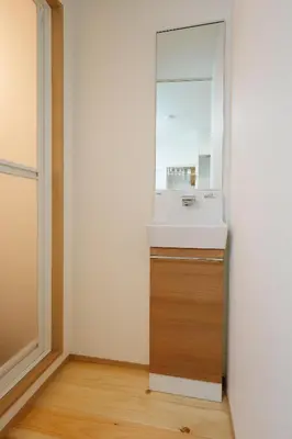 a bathroom with a sink and a mirror at Zenith Shinjuku Hinoki by Tranova in Tokyo