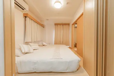 a bedroom with a large white bed in a room at Ginza301 Tsukiji 3 mins,Tsukiji Market in Tokyo