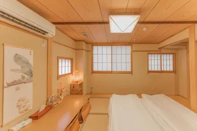 a room with a bed and a desk and windows at Ginza301 Tsukiji 3 mins,Tsukiji Market in Tokyo