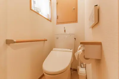 a small bathroom with a toilet and a mirror at Ginza301 Tsukiji 3 mins,Tsukiji Market in Tokyo