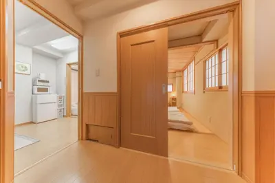 a hallway with a door leading to a kitchen at Ginza301 Tsukiji 3 mins,Tsukiji Market in Tokyo