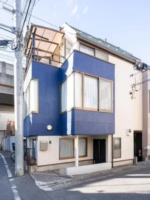 a blue and white building on a street at Familia Omorikaigan in Tokyo