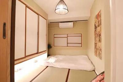 a small room with a bed and a light at Cozy Japanese Room Near Skytree with Easy Airport Access in Tokyo