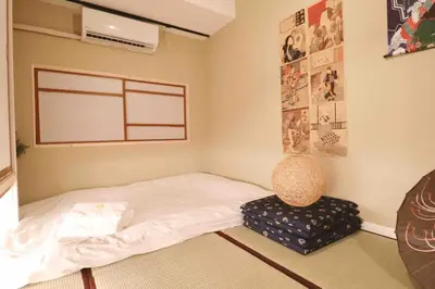 a small bedroom with a bed and a chair at Cozy Japanese Room Near Skytree with Easy Airport Access in Tokyo