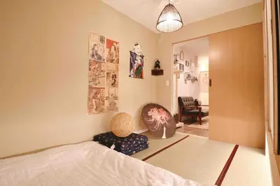 a bedroom with a bed and a living room at Cozy Japanese Room Near Skytree with Easy Airport Access in Tokyo