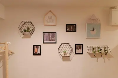 a wall with pictures and a clock on it at Cozy Japanese Room Near Skytree with Easy Airport Access in Tokyo