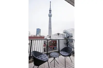 a balcony with a view of the eiffel tower at Wasabi Sky Oshiage \u62bc\u4e0a\u99c5\u5f92\u6b69\u30a2\u30d1\u30fc\u30c8 in Tokyo