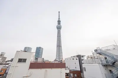 a view of the eiffel tower from the roofs of buildings at Wasabi Sky Oshiage \u62bc\u4e0a\u99c5\u5f92\u6b69\u30a2\u30d1\u30fc\u30c8 in Tokyo