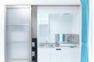 a white kitchen with a sink and a mirror at Flora Maison Kamiochiai by Tranova in Tokyo