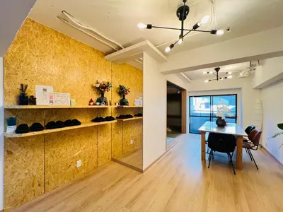 a dining room with a table and a yellow wall at Kameido Wisteria Retreat 2 Floor in Tokyo
